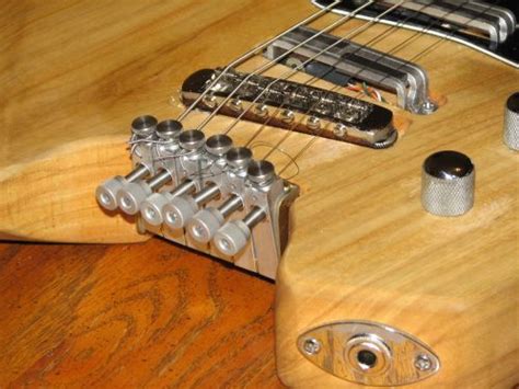 How Do You Tune a Headless Guitar, and Why Does It Sound Like a Distant Memory of a Forgotten Song?